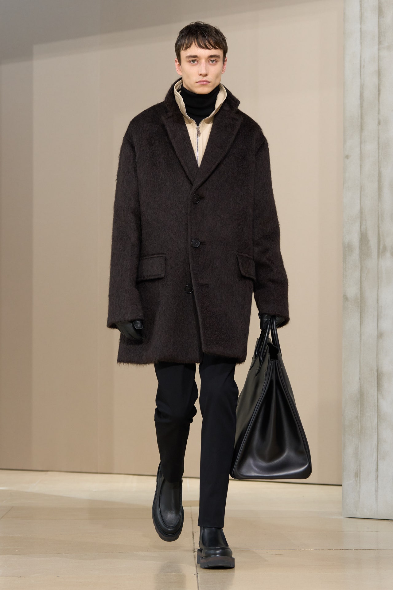 Image may contain Werner Daehn Clothing Coat Overcoat Adult Person Accessories Bag Handbag and Glove