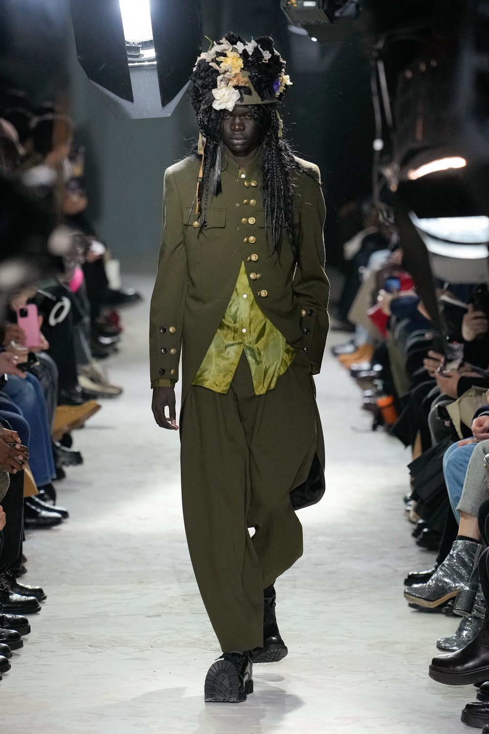 Image may contain Adult Person Electronics Mobile Phone Phone Fashion Clothing Footwear Shoe and Coat
