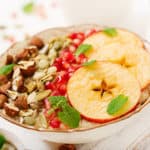 Tasty and healthy oatmeal porridge with apples, pomegranate and