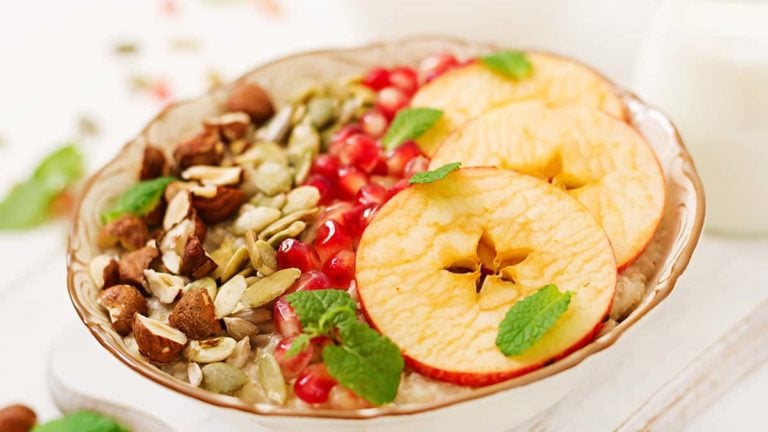 Tasty and healthy oatmeal porridge with apples, pomegranate and