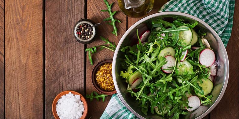Ingredients for Salad arugula, radish, cucumber and spices. Top