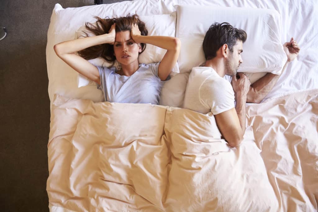 Overhead View Of Couple With Relationship Problems Lying In Bed