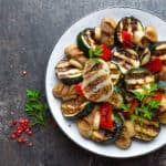 Salad with grilled vegetables and mushrooms. Vegetable salad with grilled champignons. Grilled salad on plate