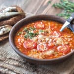 Portion of green lentil tomato soup with toasts