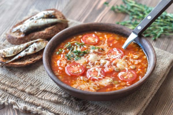 Portion of green lentil tomato soup with toasts