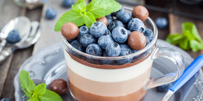 Delicious three layered chocolate mousse dessert, devorated wit