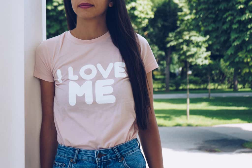 Girl is wearing t-shirt with a text " I love me"