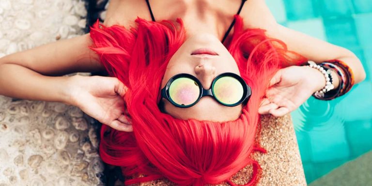 girl with red hair wig in black bikini and sunglasses