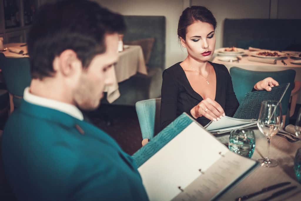 Couple reading gluten-free menu in a restaurant