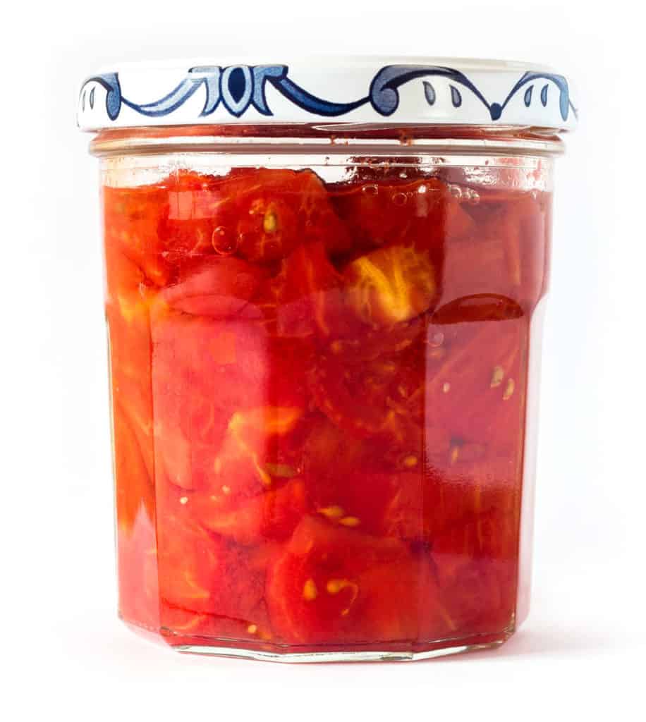 Chopped tomatoes cooked and preserved in jars.