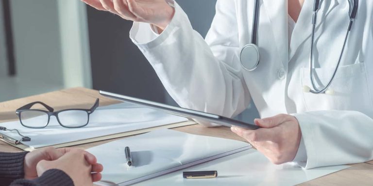 Doctor advising patient in hospital office